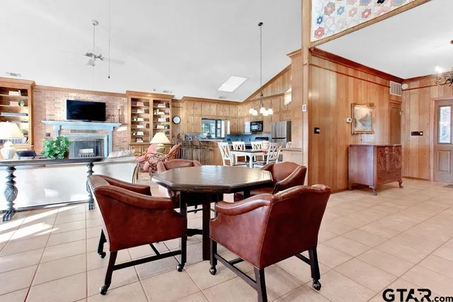 a dining room with furniture and a kitchen view