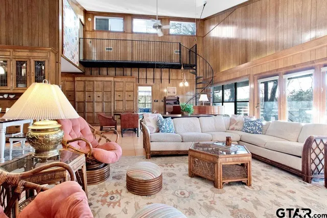 a living room with furniture a lamp and a large window