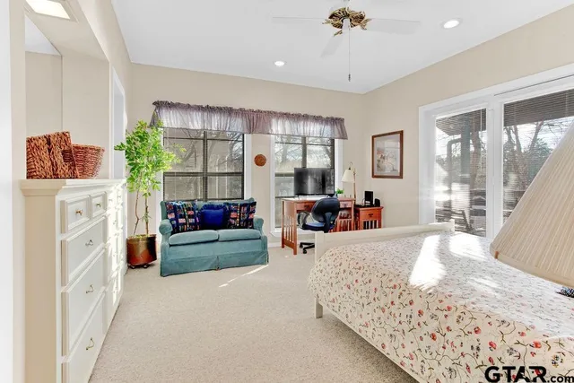 a bedroom with furniture and a large window
