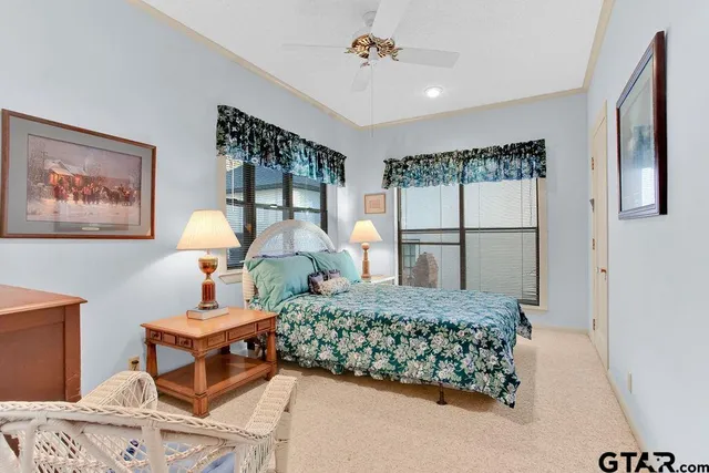 a bedroom with a large bed and a chandelier