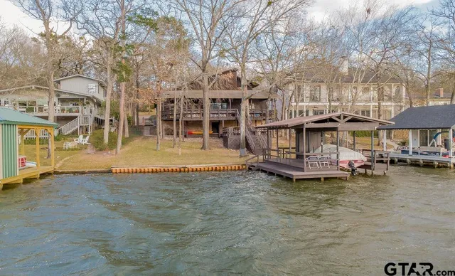 a view of a house with pool and sitting area