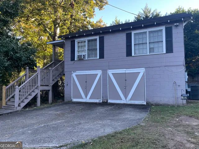 a view of a house with a yard and garage
