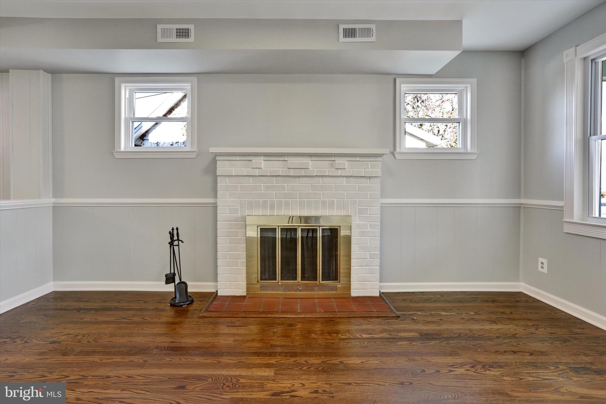 3111 Willoughby Road Baltimore, MD 21234 - Photo 11 of 45 wooden floor fireplace and windows in an empty room