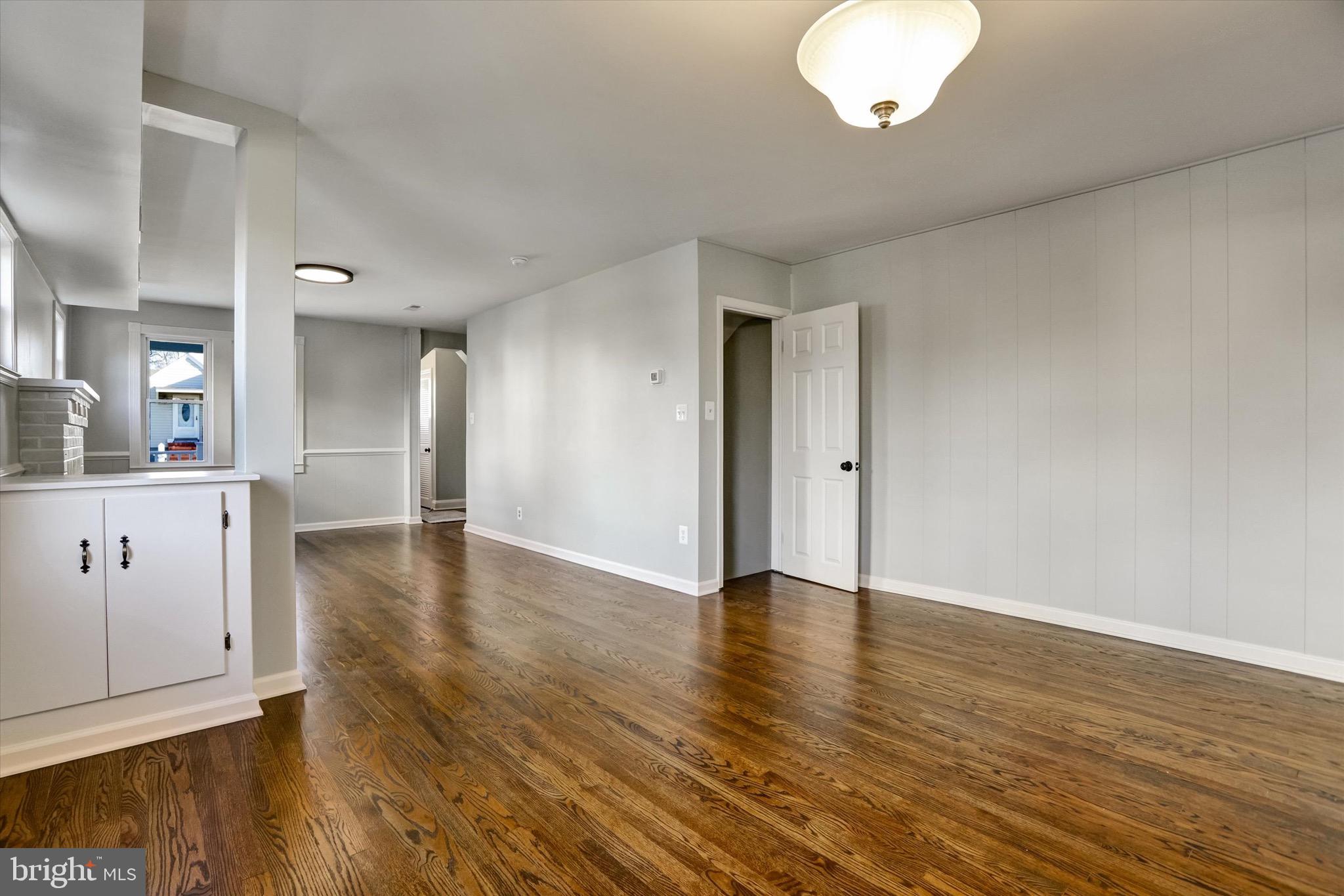 3111 Willoughby Road Baltimore, MD 21234 - Photo 14 of 45 a view of an empty room with wooden floor and a cabinet