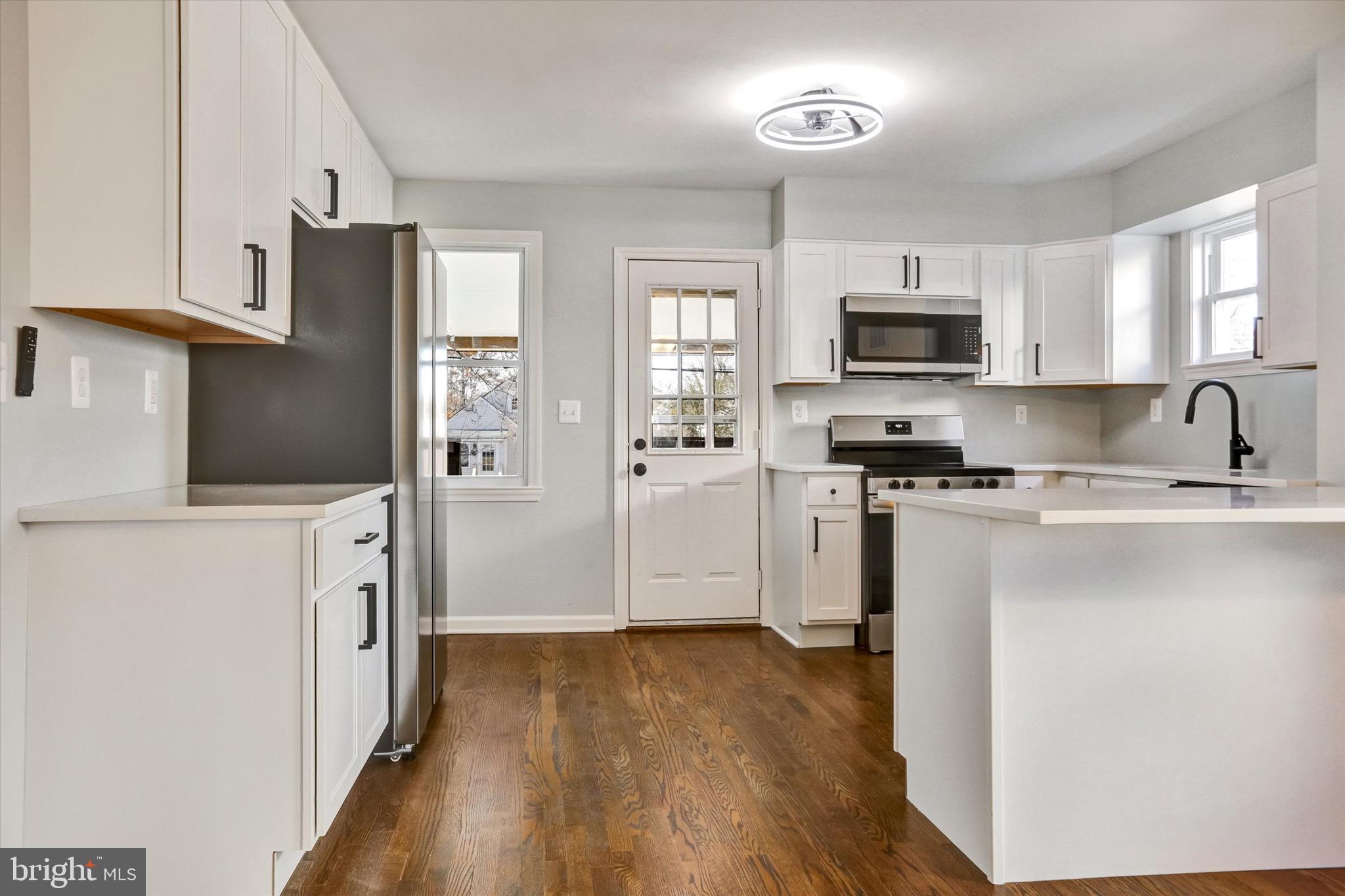 3111 Willoughby Road Baltimore, MD 21234 - Photo 15 of 45 a kitchen with stainless steel appliances a refrigerator stove microwave and sink
