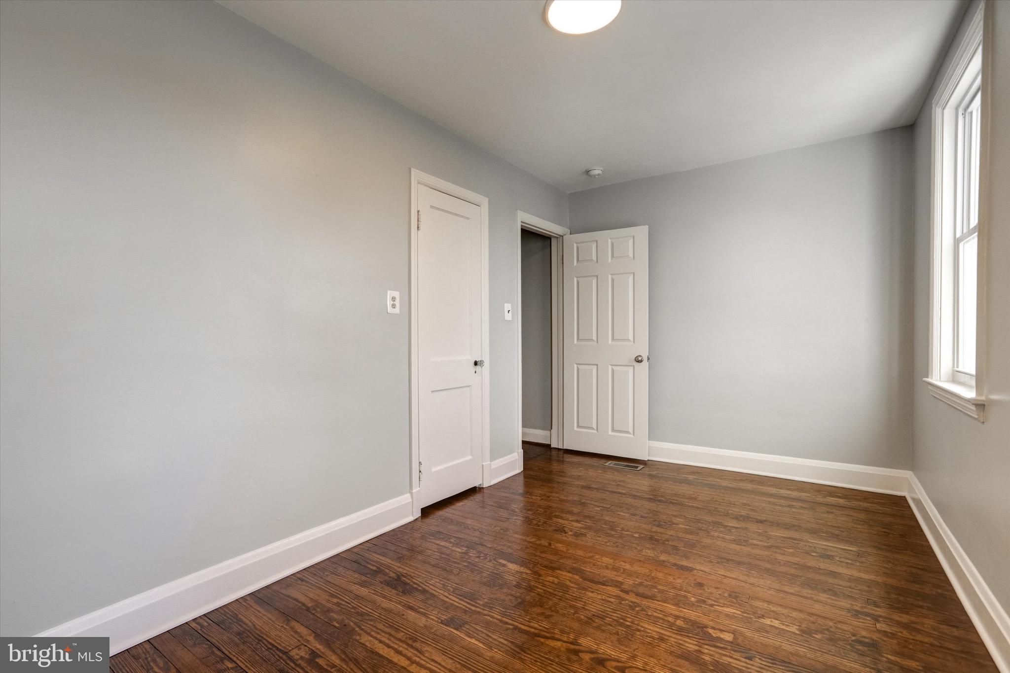 3111 Willoughby Road Baltimore, MD 21234 - Photo 22 of 45 a view of an empty room with wooden floor and window