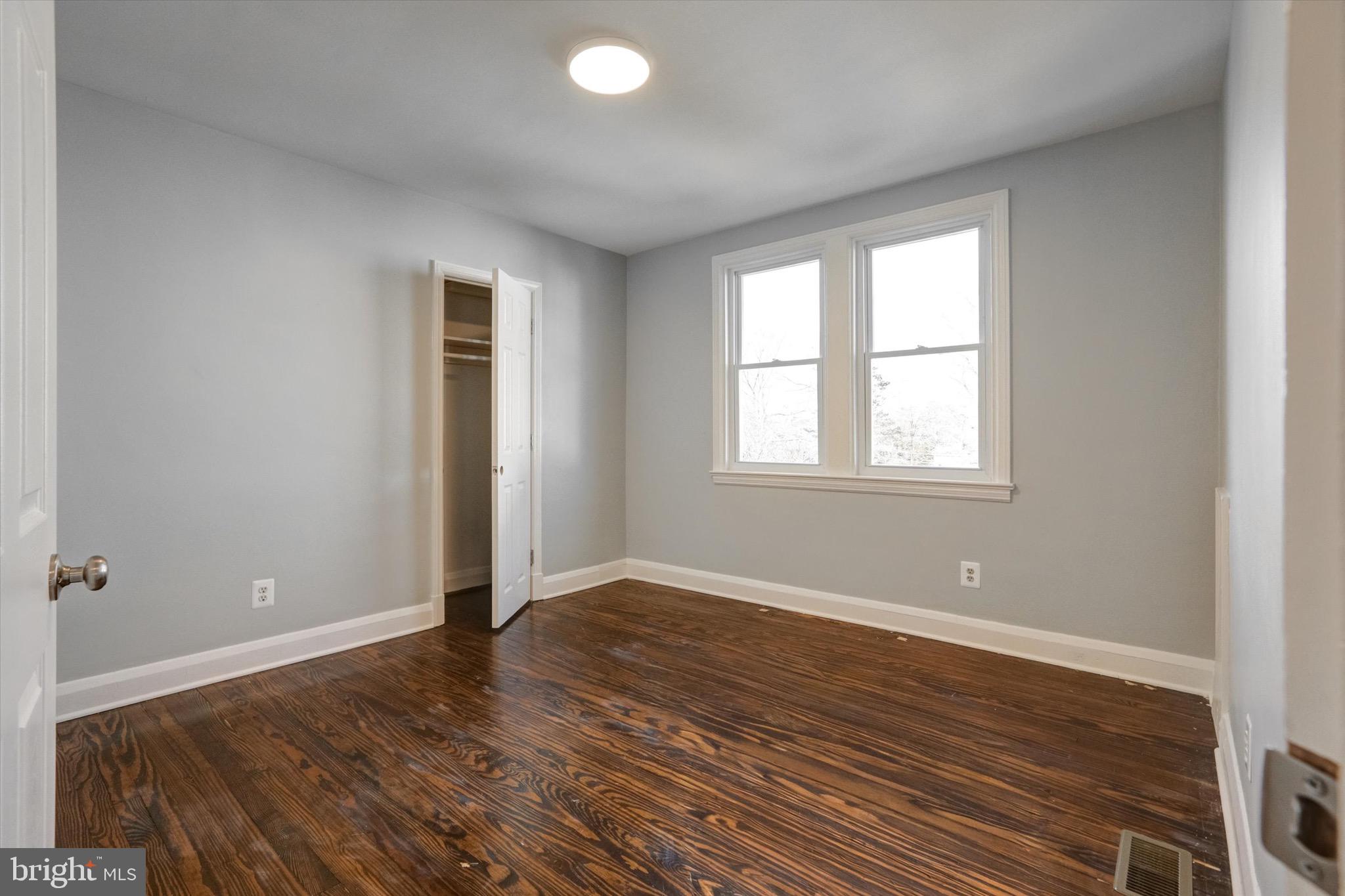 3111 Willoughby Road Baltimore, MD 21234 - Photo 24 of 45 an empty room with wooden floor and windows