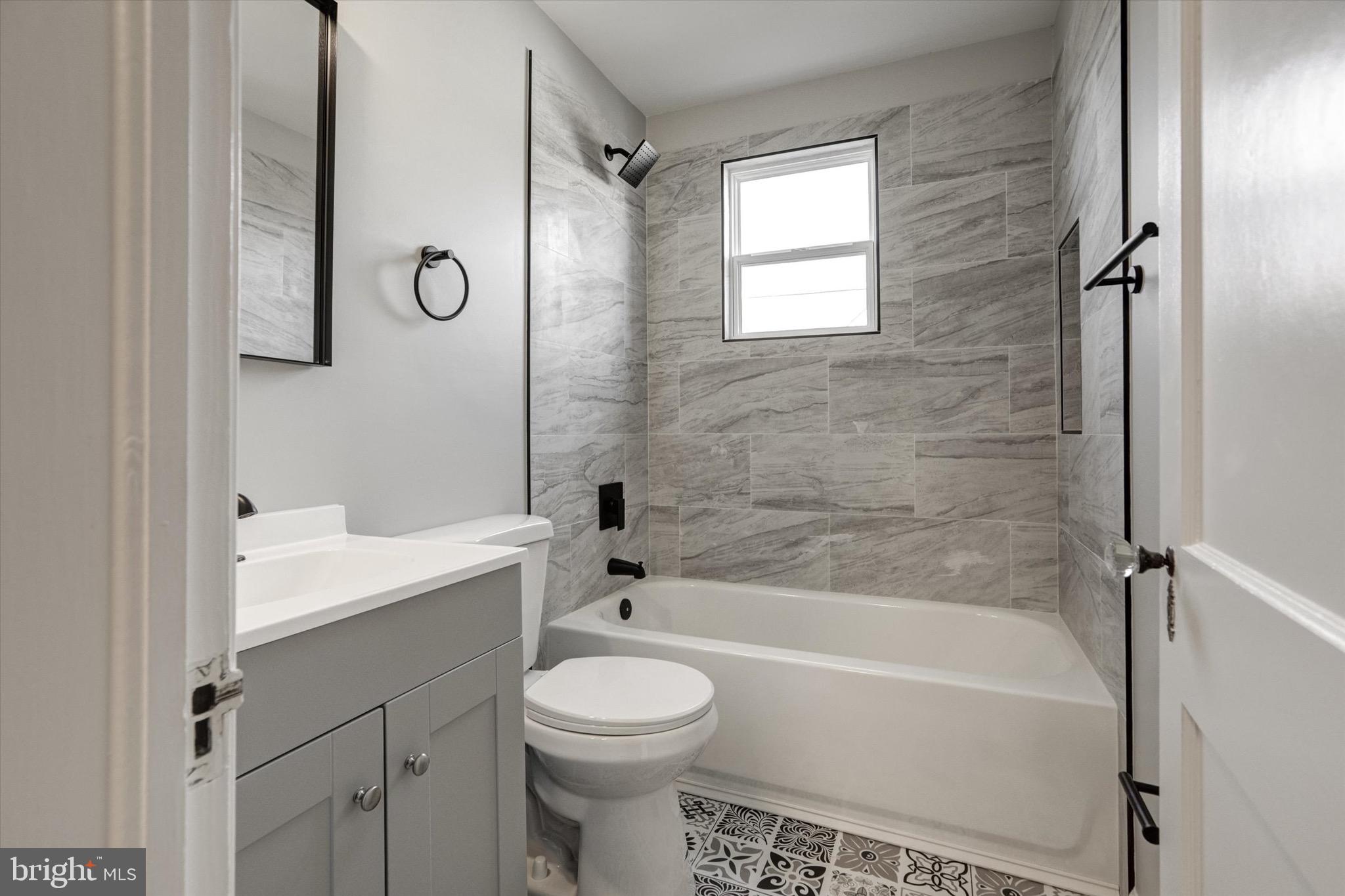 3111 Willoughby Road Baltimore, MD 21234 - Photo 28 of 45 a bathroom with a bathtub shower sink vanity mirror and toilet