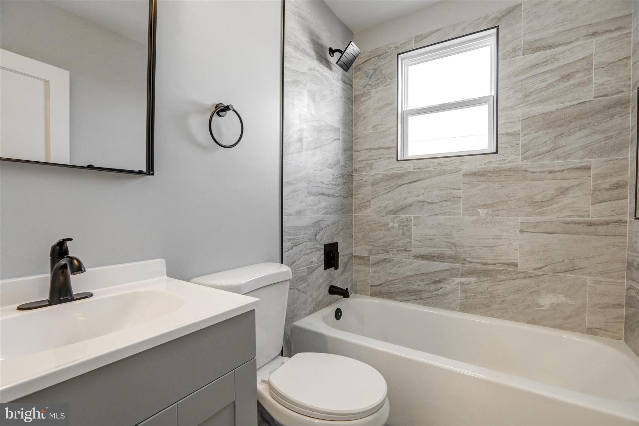 3111 Willoughby Road Baltimore, MD 21234 - Photo 29 of 45 a bathroom with a sink toilet a bathtub and shower