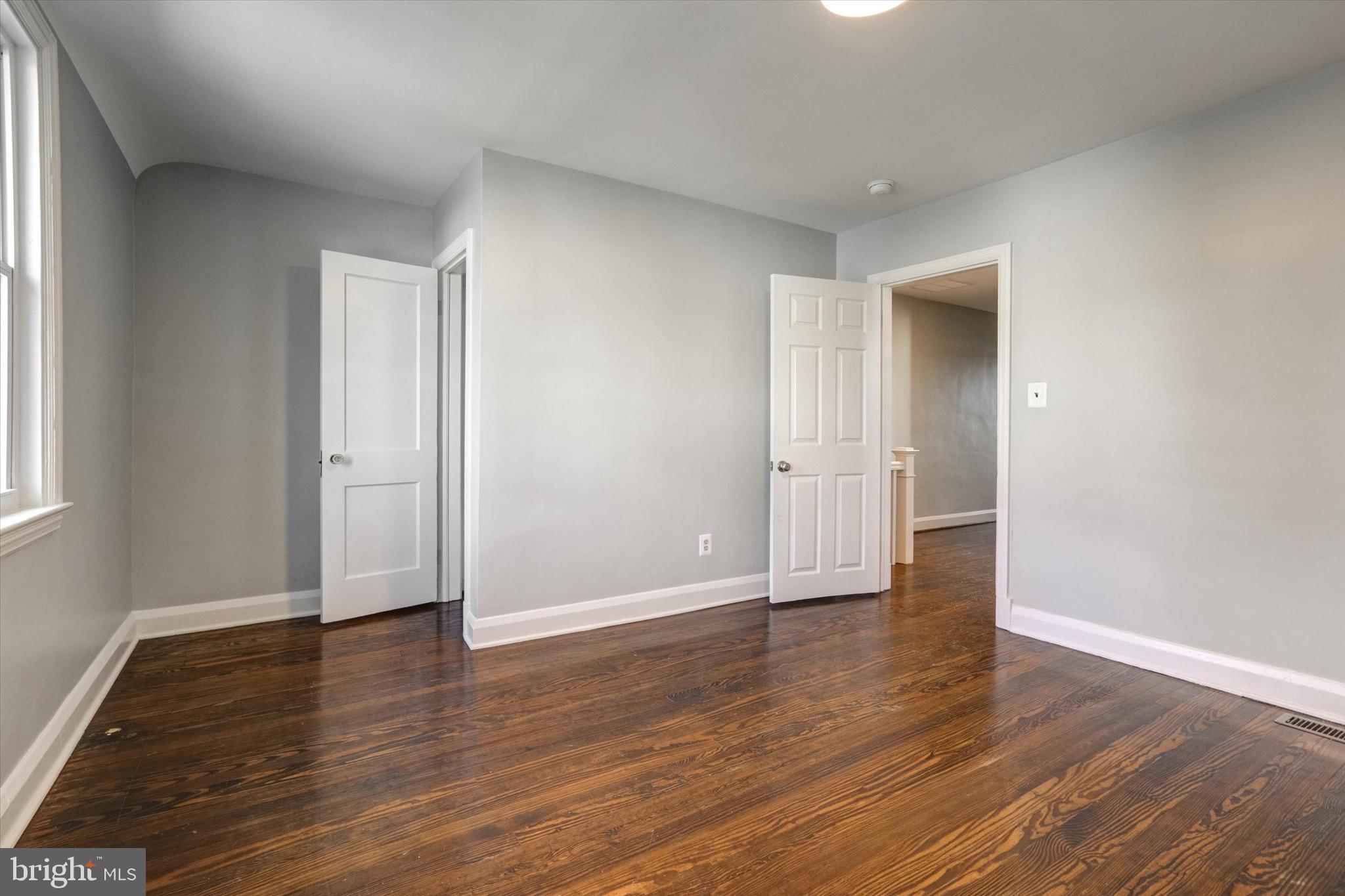 3111 Willoughby Road Baltimore, MD 21234 - Photo 30 of 45 an empty room with wooden floor and windows