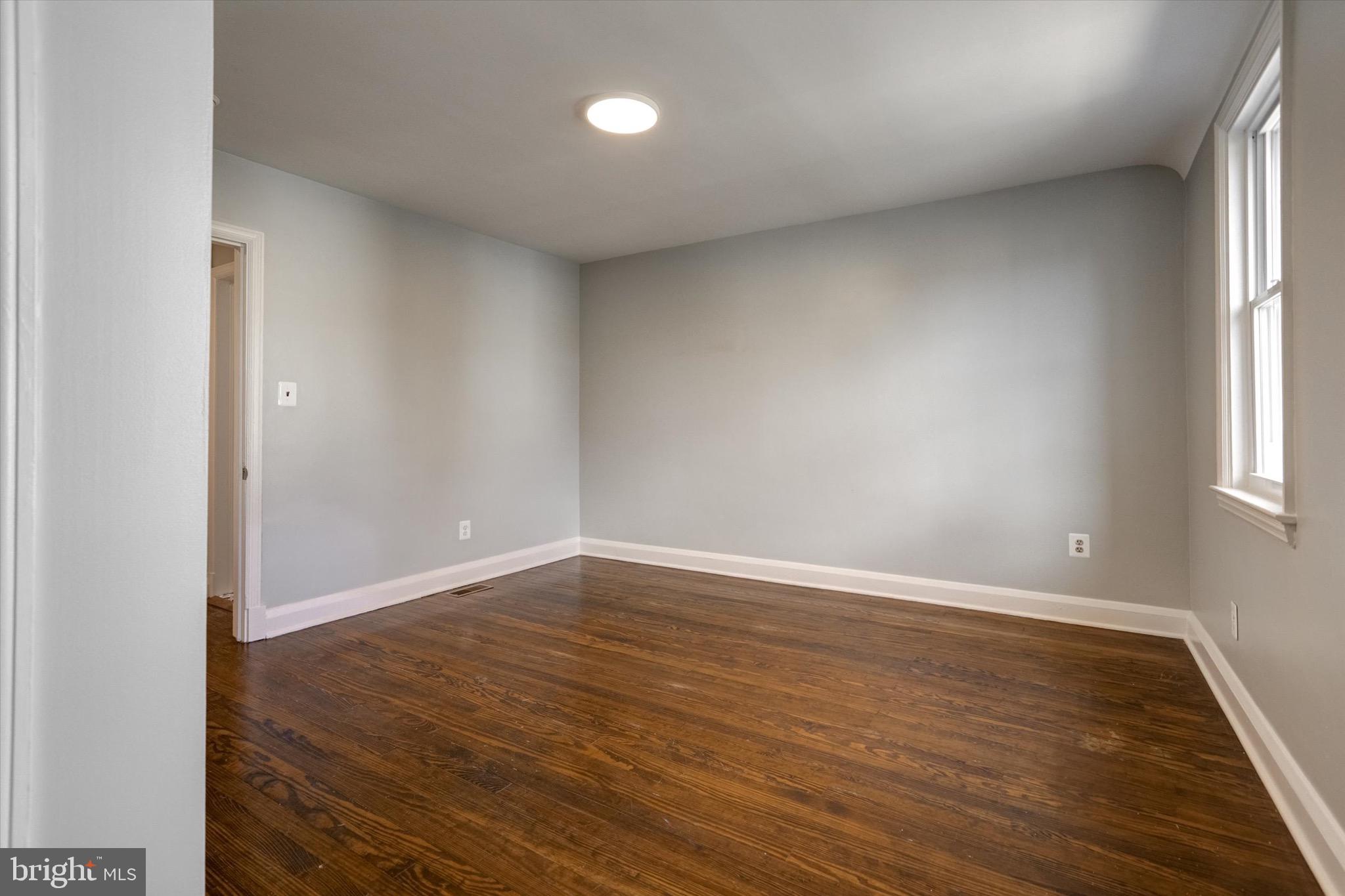 3111 Willoughby Road Baltimore, MD 21234 - Photo 31 of 45 wooden floor in an empty room with a window