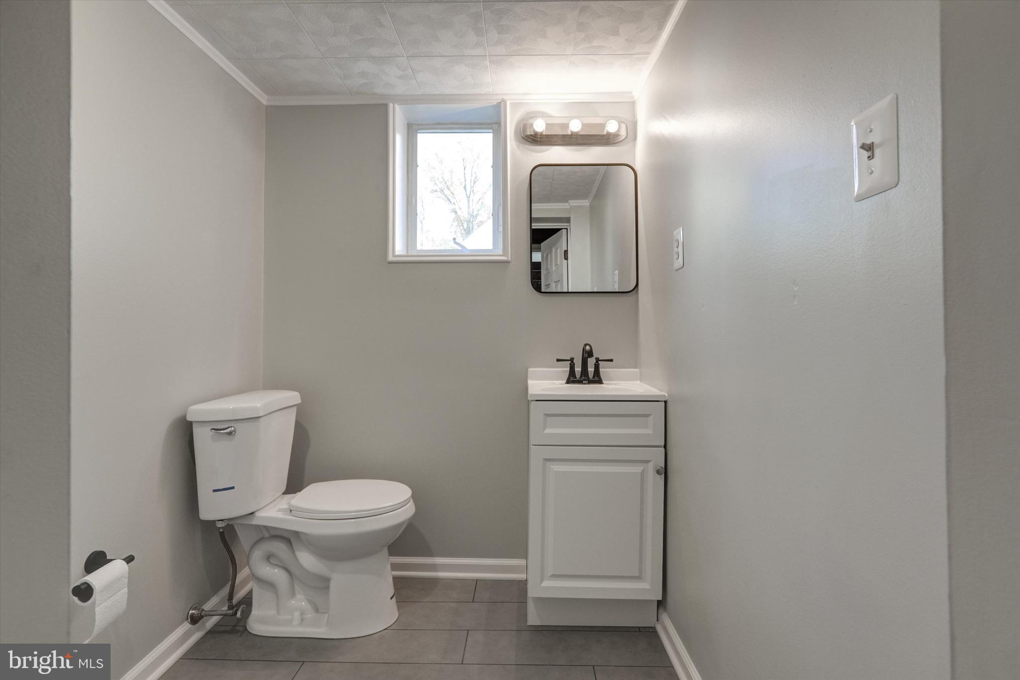 3111 Willoughby Road Baltimore, MD 21234 - Photo 37 of 45 a bathroom with a toilet sink and mirror