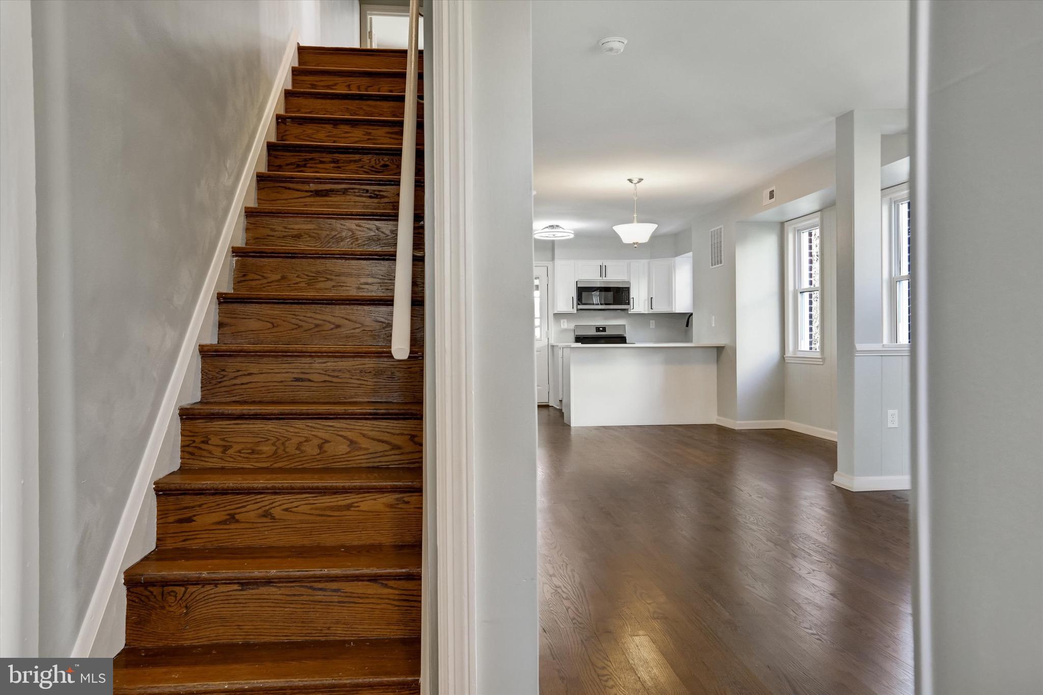 3111 Willoughby Road Baltimore, MD 21234 - Photo 10 of 45 a view of a kitchen with wooden floor electronic appliances and stairs