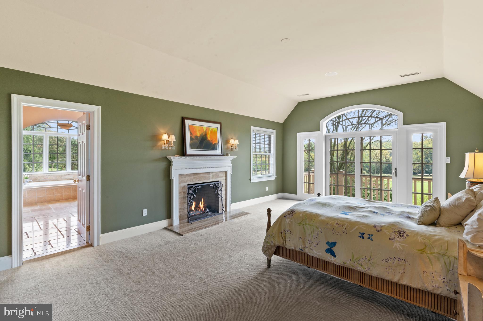 335 Boot Road Malvern, PA 19355 - Photo 31 of 65 a spacious bedroom with a bed and a fireplace