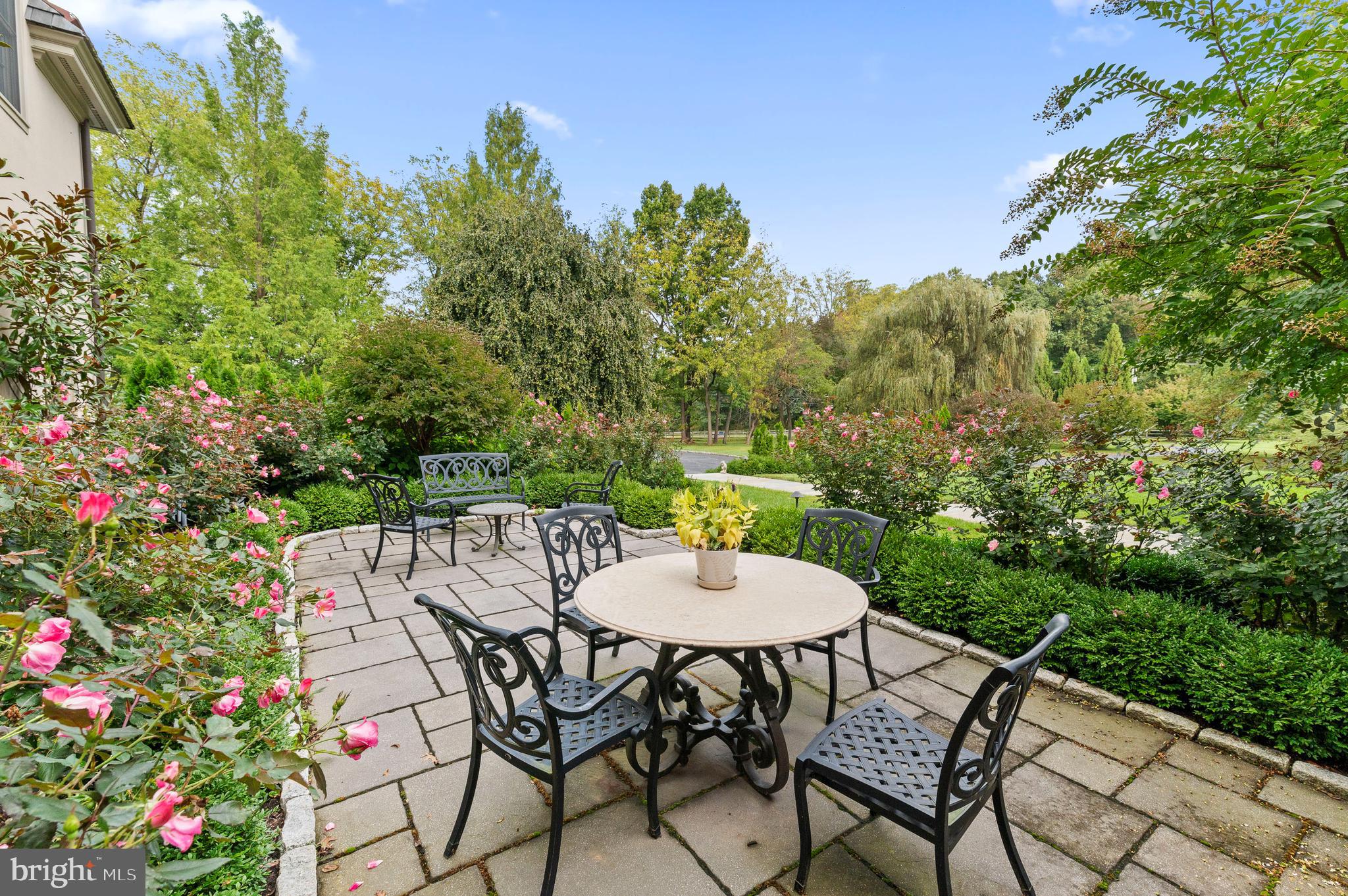 335 Boot Road Malvern, PA 19355 - Photo 56 of 65 a backyard of a house with table and chairs plants and large trees