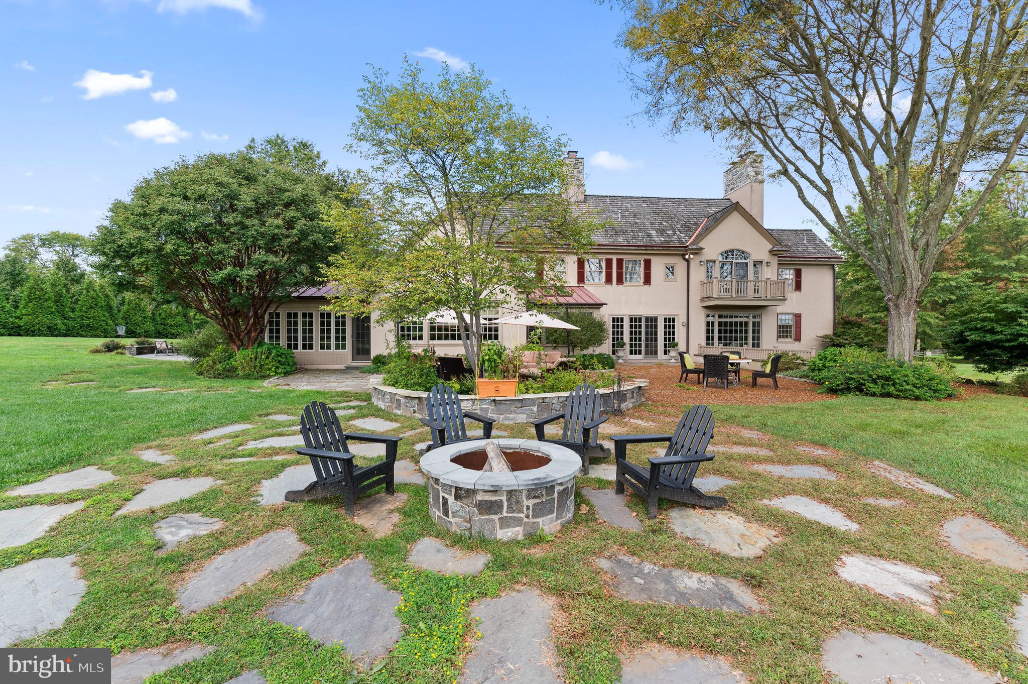 335 Boot Road Malvern, PA 19355 - Photo 59 of 65 a view of a patio with table and chairs and potted plants and large trees