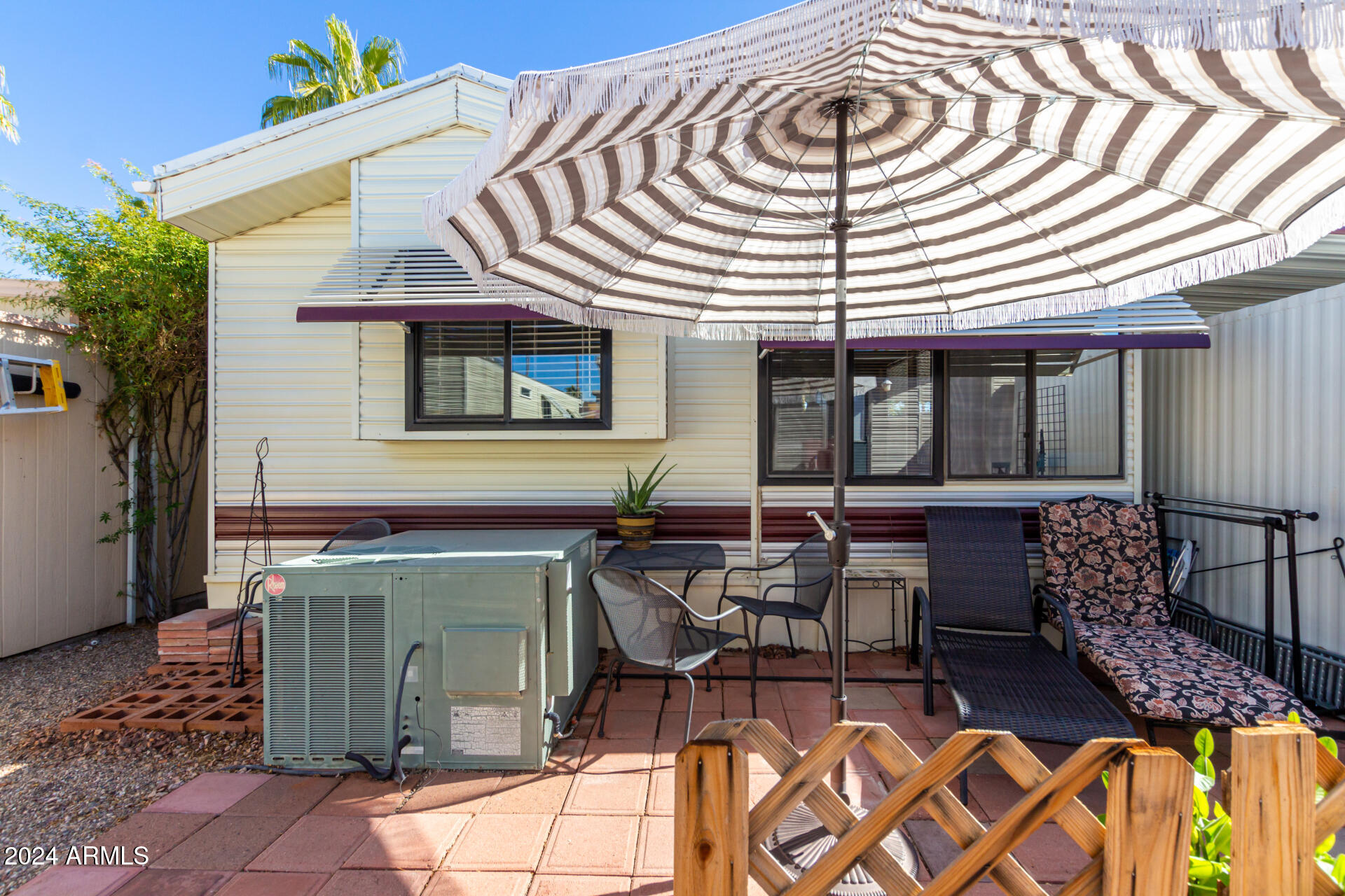 4555 South Mission Road, Unit J343 Tucson, AZ 85746 - Photo 25 of 26 a view of a patio with table and chairs and potted plants