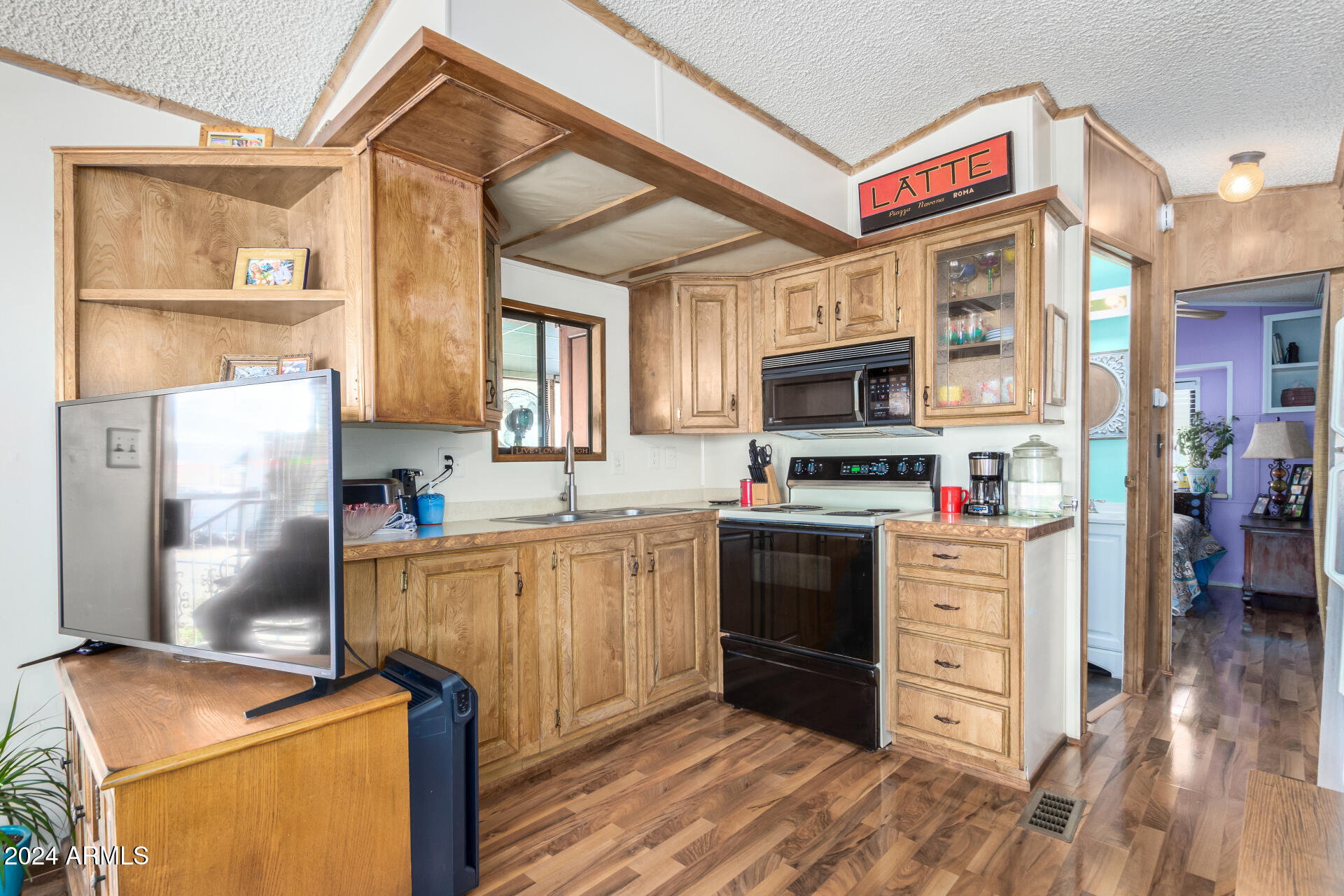 4555 South Mission Road, Unit J343 Tucson, AZ 85746 - Photo 8 of 26 a kitchen with stainless steel appliances granite countertop a refrigerator stove and oven