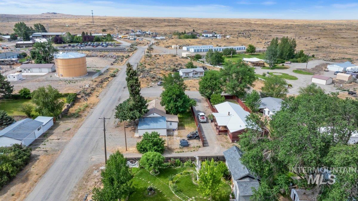 418 South Date Street Shoshone, ID 83352 - Photo 32 of 36 Aerial perspective showcasing a residential area amidst a rustic, expansive landscape