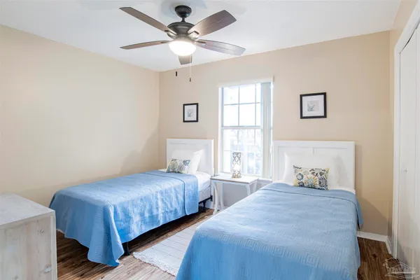 a bedroom with two large bed and a window