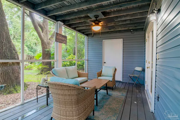 a outdoor living space with patio furniture and wooden floor