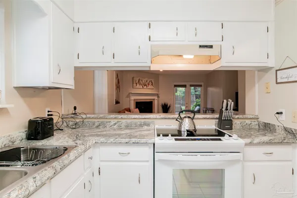 a kitchen with stainless steel appliances granite countertop a sink and cabinets