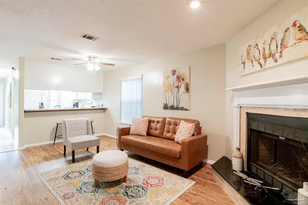 a living room with furniture and a fireplace