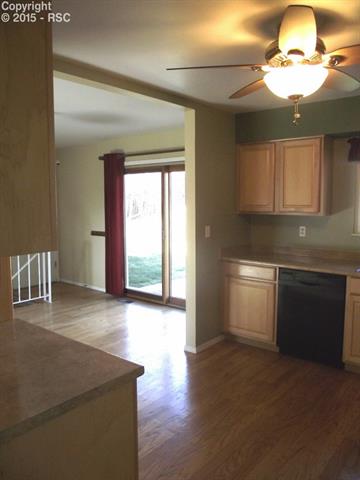 4851 Del Sol Road Colorado Springs, CO 80918 - Photo 2 of 8 View from kitchen to dining and the walk-out to the patio areas where you can enjoy the Colorado sunshine.