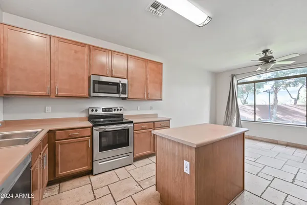 a kitchen with a stove top oven sink and cabinets