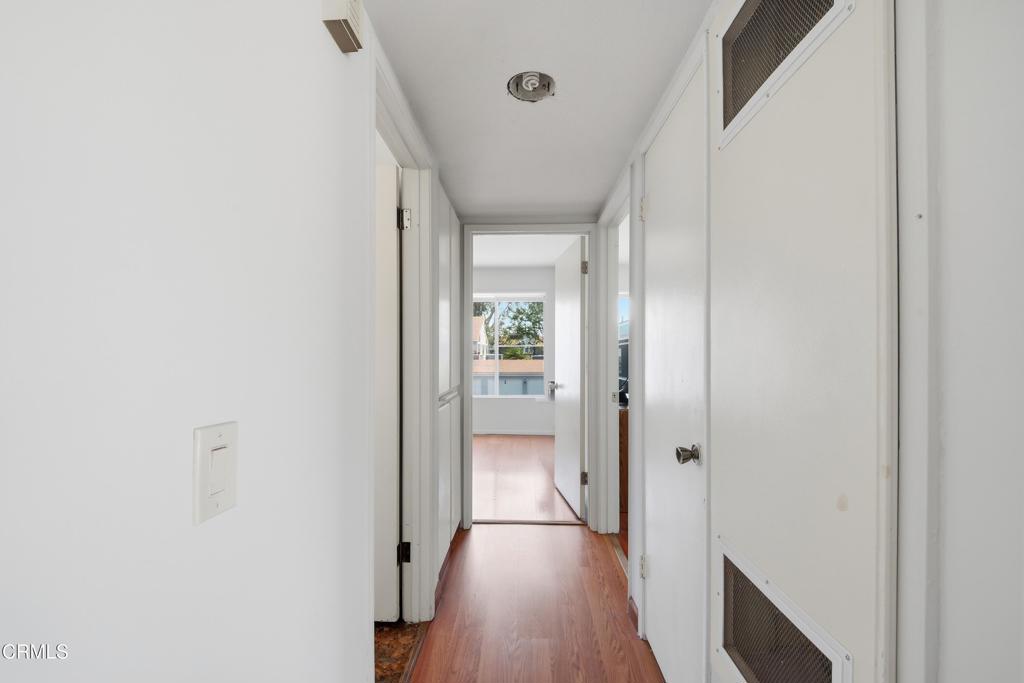 5154 Jefferson Square Oxnard, CA 93033 - Photo 14 of 23 a view of a hallway with wooden floor and staircase