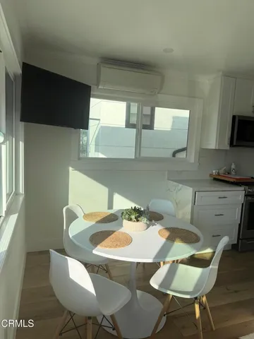 a kitchen with a table chairs and a kitchen