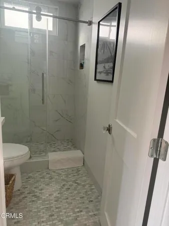 a bathroom with a shower and a toilet