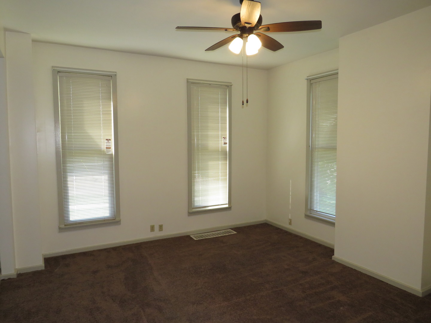 304 East Main Street, Unit A Ottawa, IL 61350 - Photo 11 of 22 an empty room with windows and fan