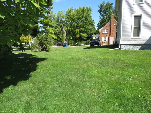 a view of house with backyard
