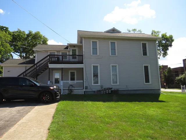 a front view of a house with a garden