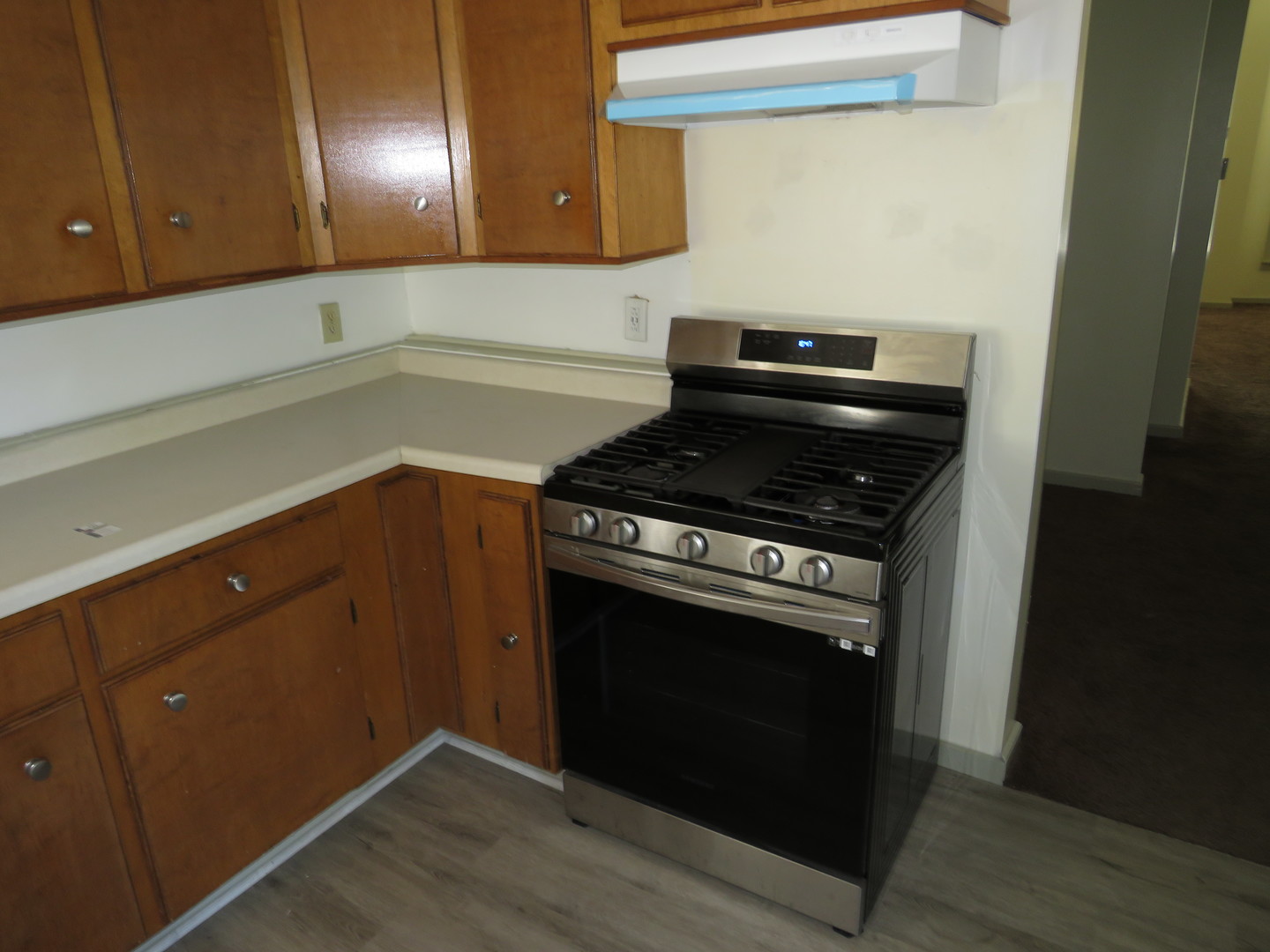 304 East Main Street, Unit A Ottawa, IL 61350 - Photo 6 of 22 a kitchen with granite countertop a stove and a wooden cabinets