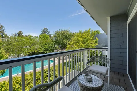 a balcony with wooden floor and outdoor space
