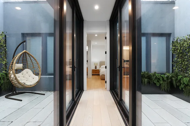 a view of lobby with mirror and furniture