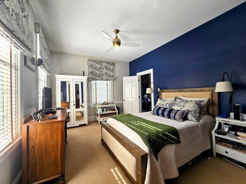 199 Rhode Island Road Lakeville, MA 02347 - Photo 17 of 30 a bedroom with double bed windows and a flat screen tv