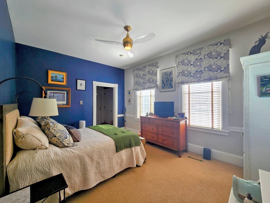 199 Rhode Island Road Lakeville, MA 02347 - Photo 18 of 30 a spacious bedroom with a bed and a chandelier
