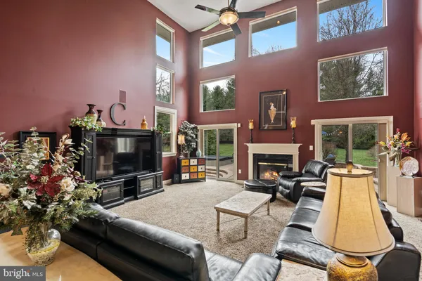 a living room with furniture a flat screen tv and a window