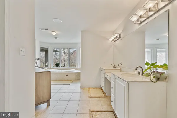 a bathroom with a granite countertop sink a mirror and shower