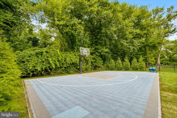 a view of a patio with couches and table and chairs with wooden floor and fence