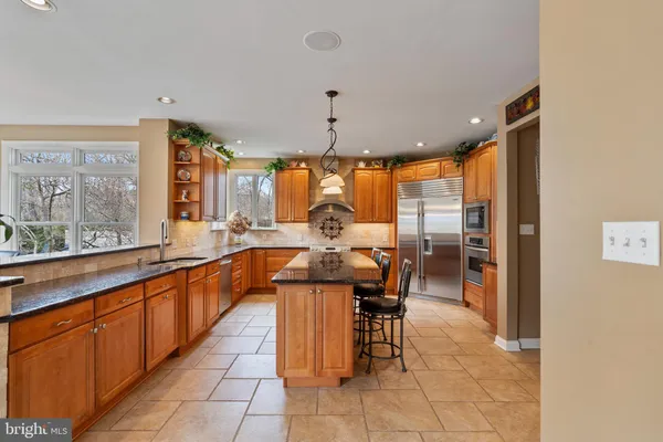 a dining table chairs and a chandelier