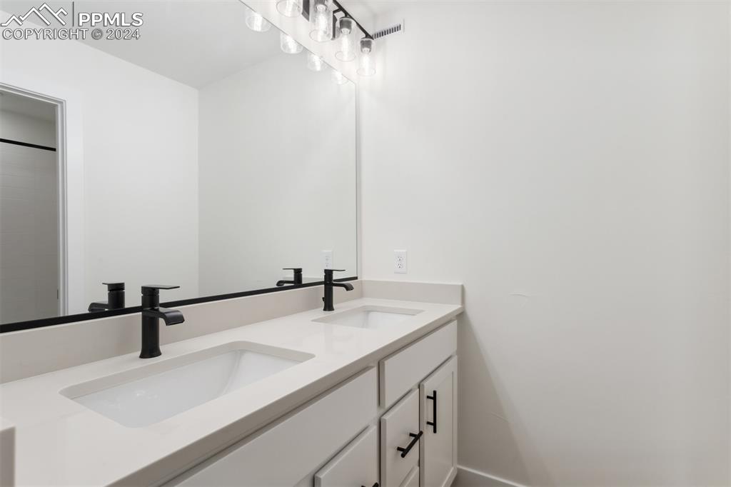 42972 Colonial Trail Elizabeth, CO 80107 - Photo 11 of 17 a bathroom with a sink and a mirror