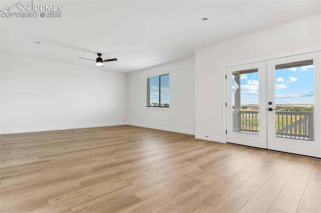 42972 Colonial Trail Elizabeth, CO 80107 - Photo 3 of 17 an empty room with wooden floor and windows