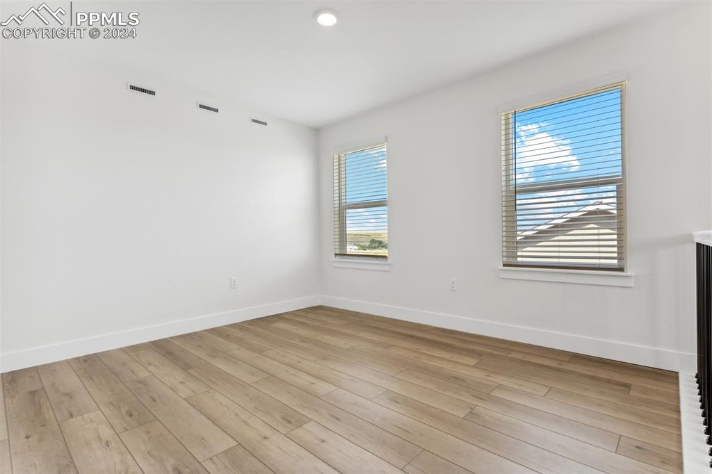 42972 Colonial Trail Elizabeth, CO 80107 - Photo 7 of 17 a view of an empty room with wooden floor and a window