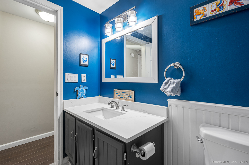 437 Somers Road Ellington, CT 06029 - Photo 13 of 40 a bathroom with a sink a toilet and mirror