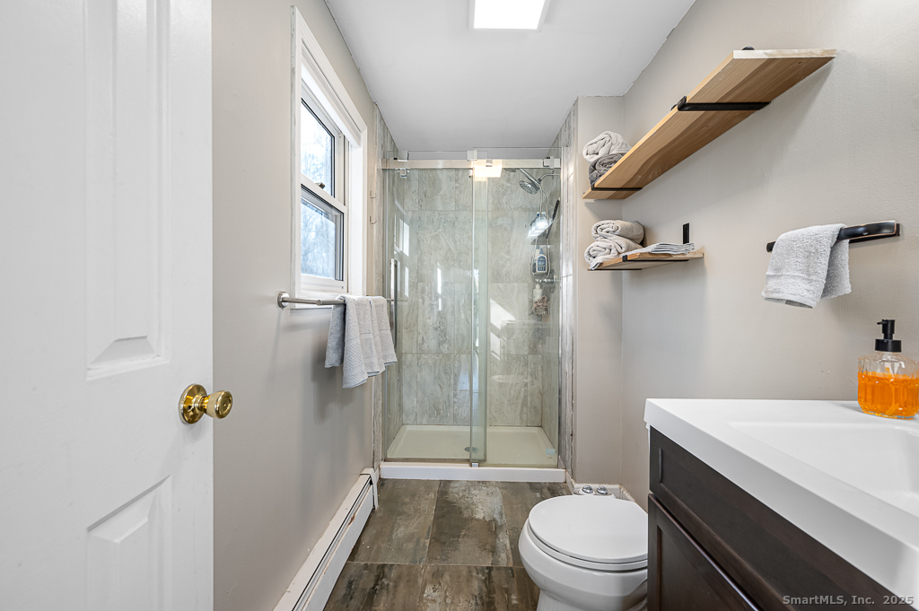 437 Somers Road Ellington, CT 06029 - Photo 18 of 40 a bathroom with a sink toilet and shower