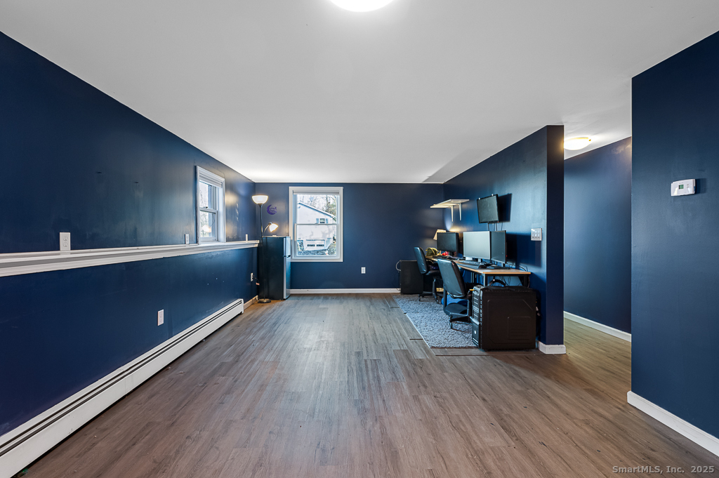 437 Somers Road Ellington, CT 06029 - Photo 22 of 40 a living room with furniture and a wooden floor